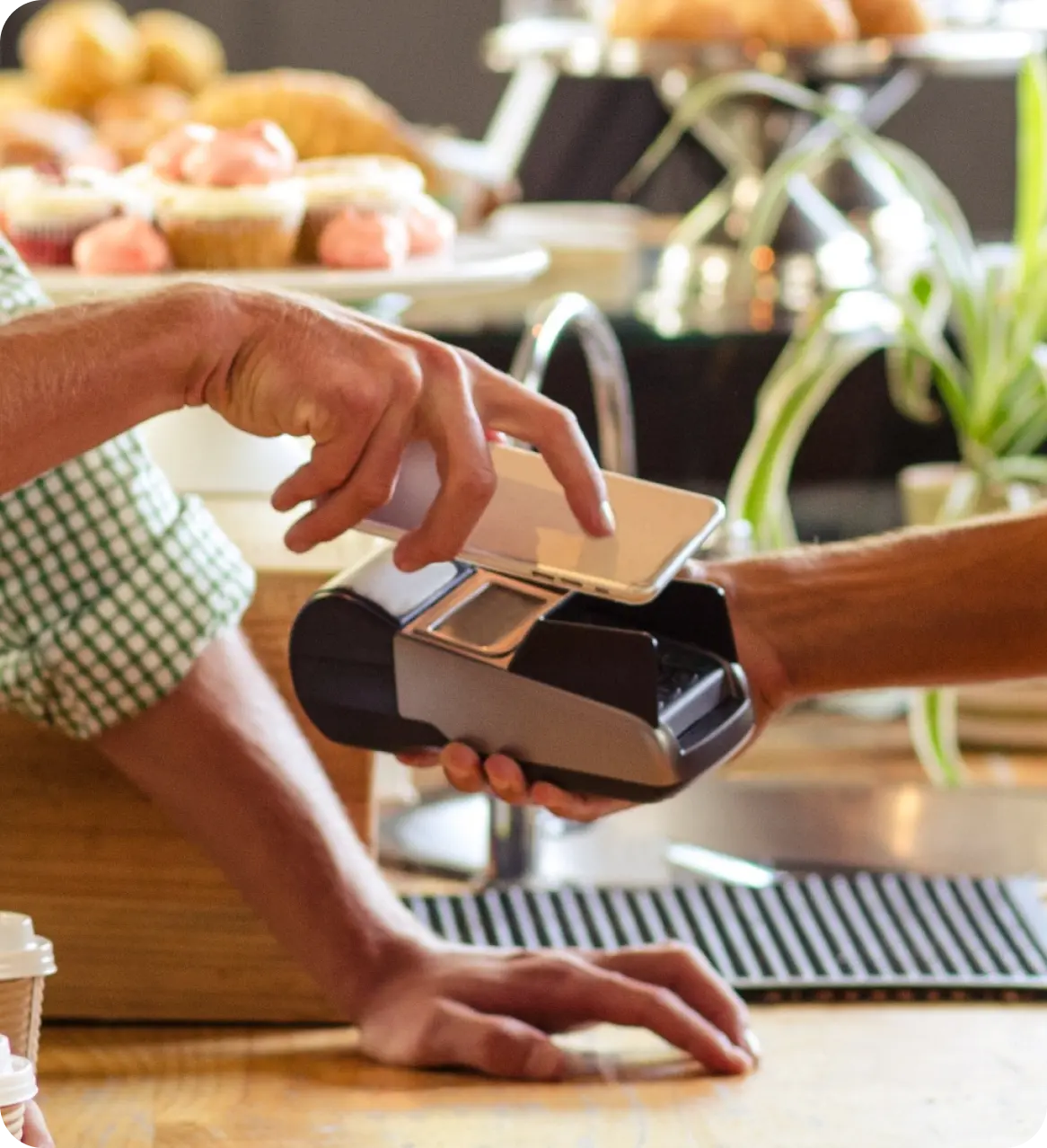 Contactless mobile payment being processed at a bakery counter